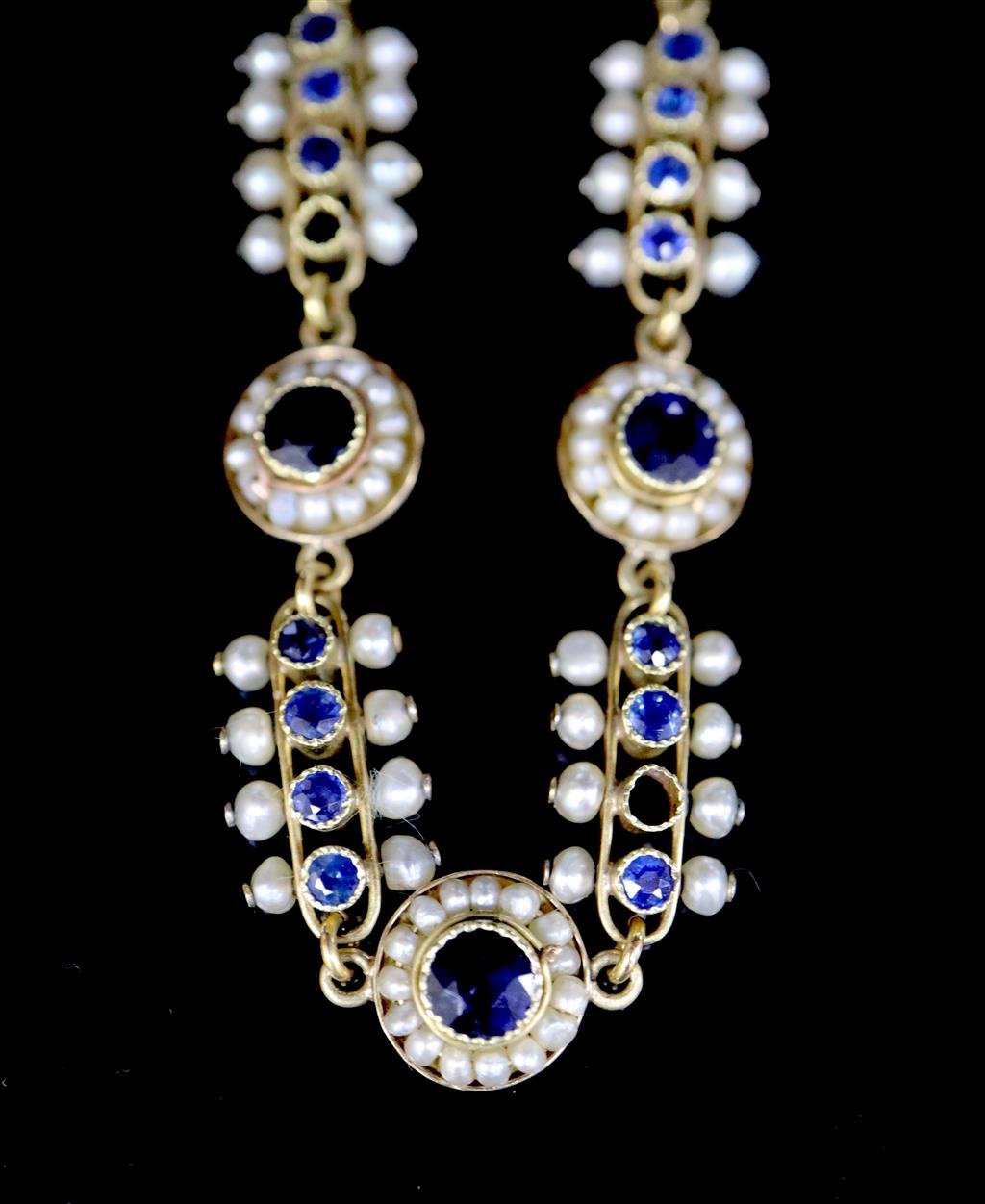 A late 19th/early 20th century French 18ct gold, sapphire and seed pearl set bar and circular link bracelet,